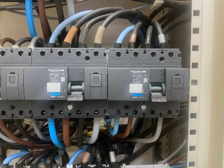 Intérieur d'installation électrique industrielle avec disjoncteur haute tension Schneider Electric monté dans armoire métallique